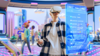 Someone in a digital environment wearing a VR headset interacting with a holographic screen