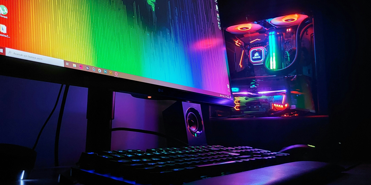 RGB-lit gaming setup with monitor, keyboard, and custom PC.