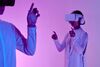 Two people with virtual reality headsets on