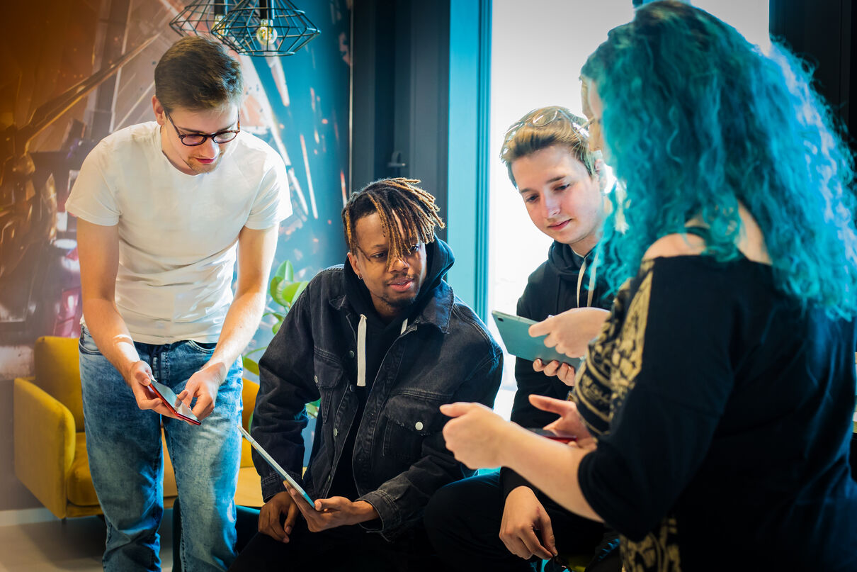 Four people looking at a phone