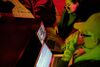People crowding around a computer screen looking at editing software