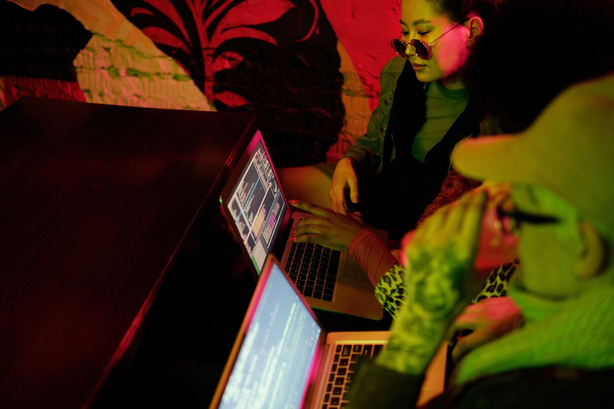 People crowding around a computer screen looking at editing software