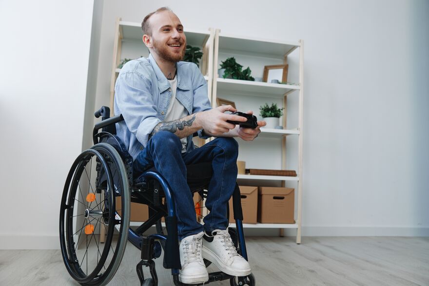 A person in a wheelchair playing a video game