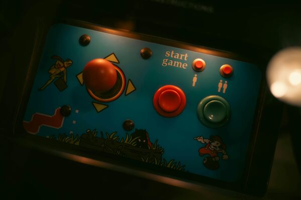 Retro Video Game pad with 2 buttons and a joystick on a classic platformer themed background
