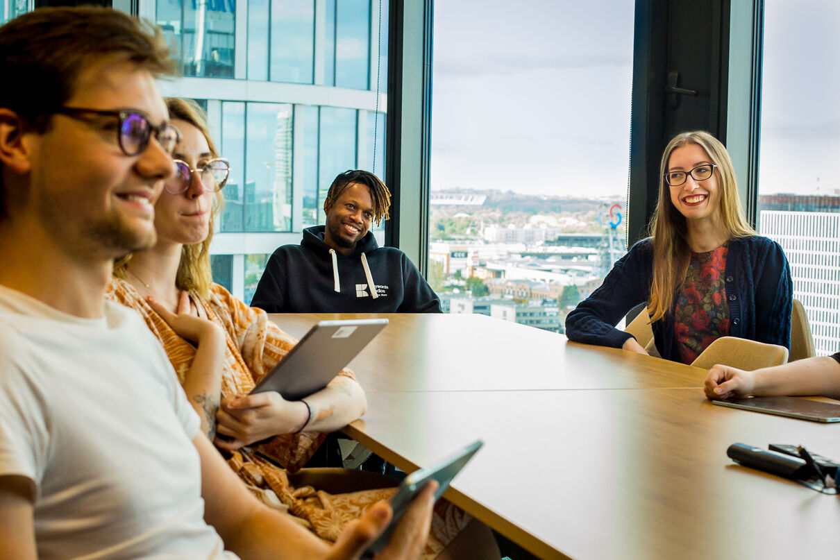 Four people sitting at a meeting table