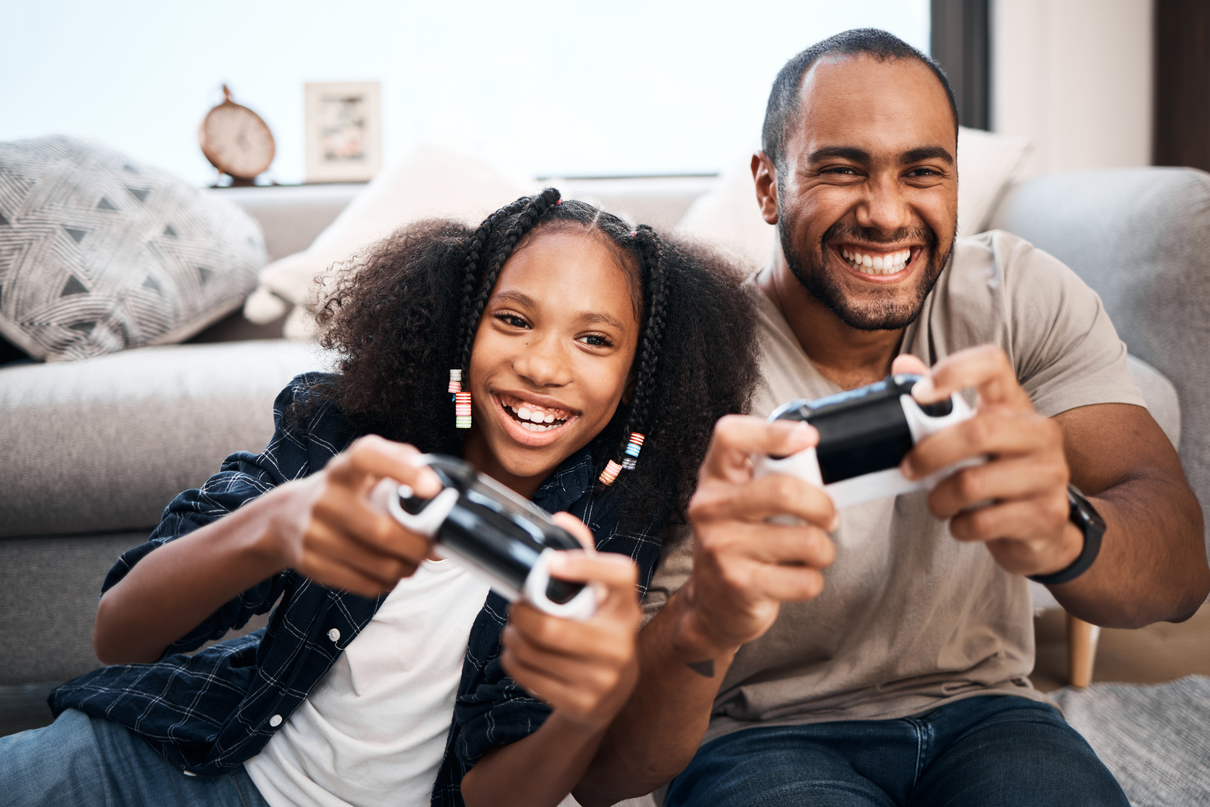 A man and a child playing with video game controllers
