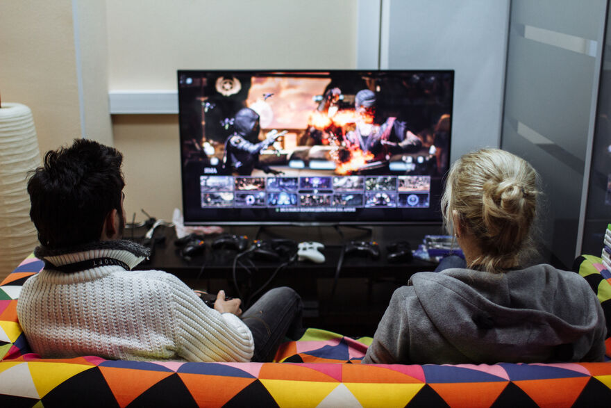 A man and a woman playing a game together on a TV. 