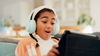 A young girl playing on a tablet