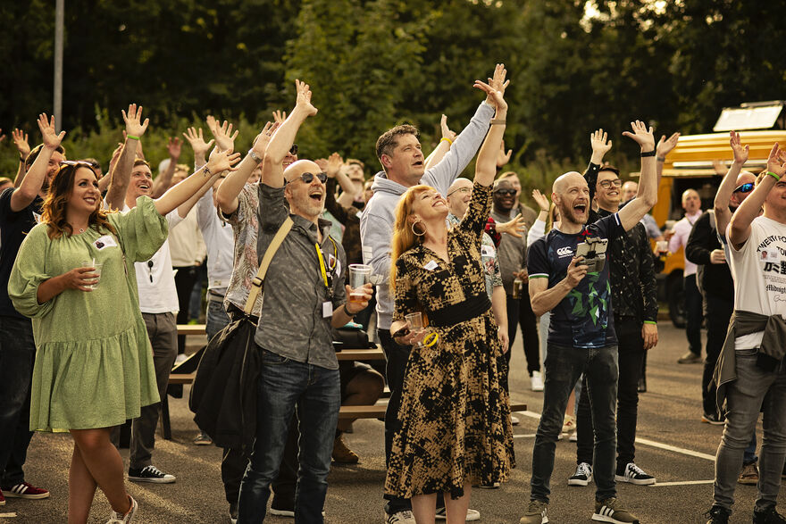 d3t at their garden party waving to the sky