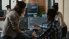 A team of developers huddled around a computer