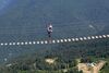 Person crossing bridge over deep valley