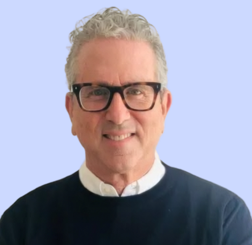 A headshot of Jonathan Zweig on a light blue background