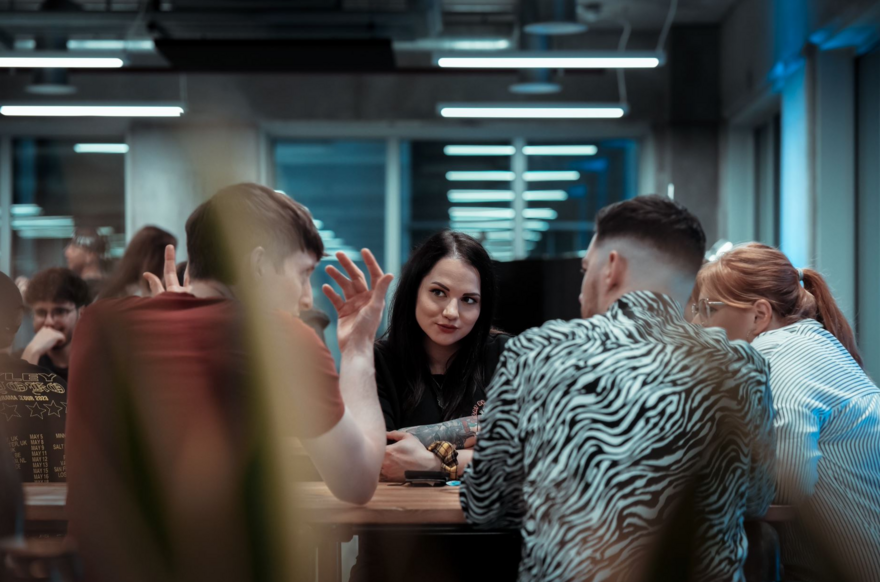 Group of people sitting around a table talking