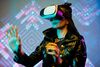 Woman wearing VR headset interacting with virtual space in neon-lit setting.