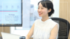 Aya Shimiu smiling while sat at her desk