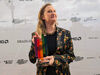 A woman holding an award
